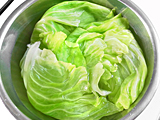 鍋にたっぷりの湯を沸かし、キャベツの葉を茹でる。茹で上ったら水にさらし、冷やす。